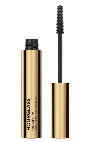 Hourglass Unlocked Instant Extensions Mascara open beside its applicator on a white background