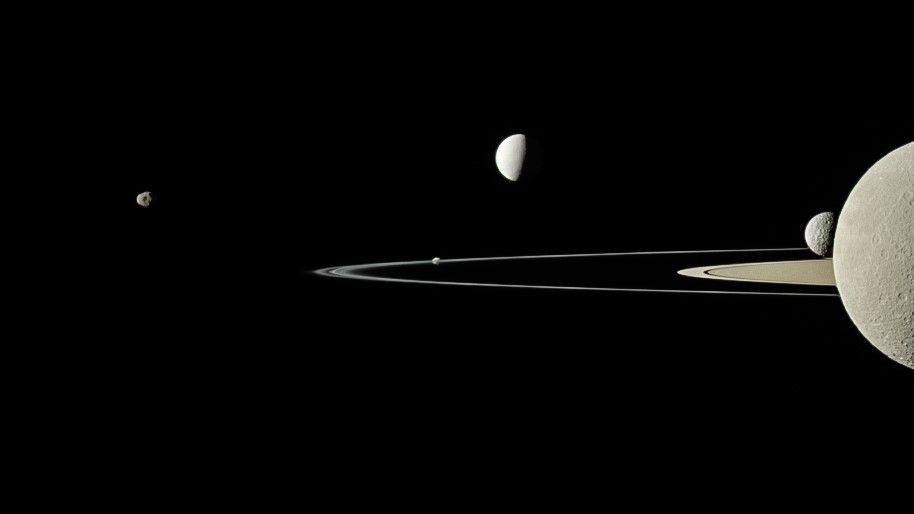 Saturn has 124 moons, Five of Saturn&#039;s moons from left to right are Janus, Pandora, Enceladus, Mimas and Rhea. Saturn is on the right.