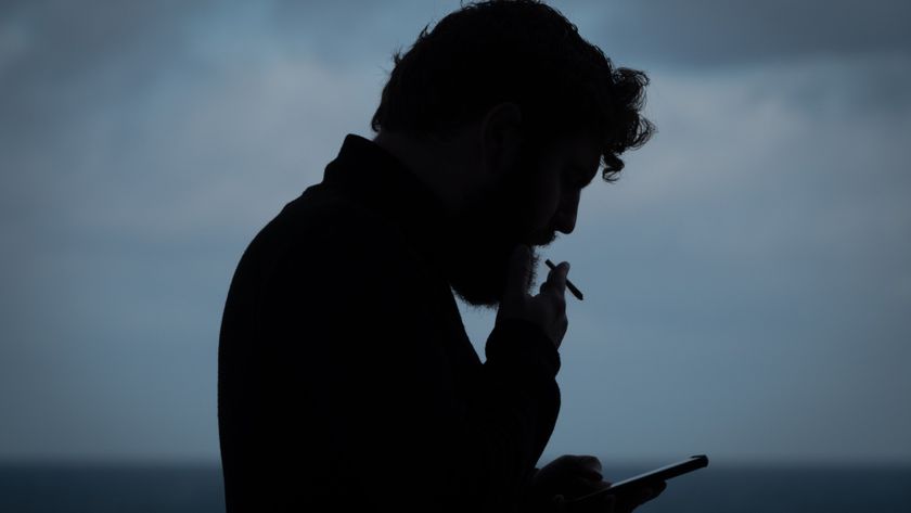 PORTSMOUTH, UNITED KINGDOM - OCTOBER 20: A man smokes a cigarette while he looks at a smart phone screen on October 20, 2024 in Portsmouth, England. (Photo by Matt Cardy/Getty Images)