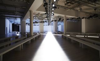 a diagonal cruciform runway, projected onto the floor in celestial light