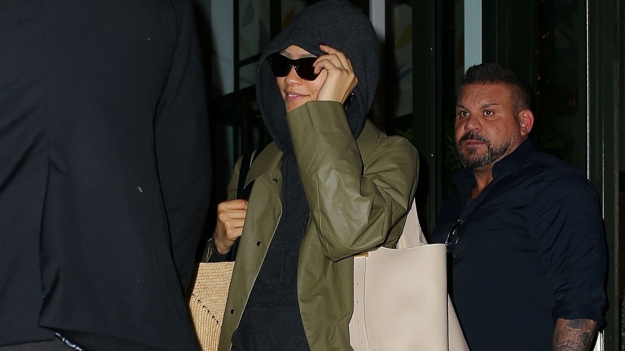 Zendaya leaves her hotel for the Met Gala wearing a hoodie and double bags