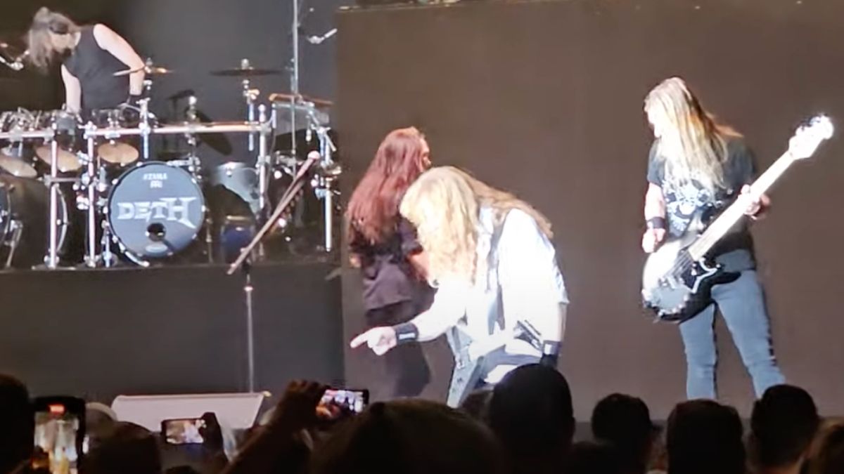 Dave Mustaine points at a security guard from the stage