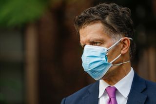 Close-up of Dr. Grant Colfax wearing two face masks at a recent press conference in California