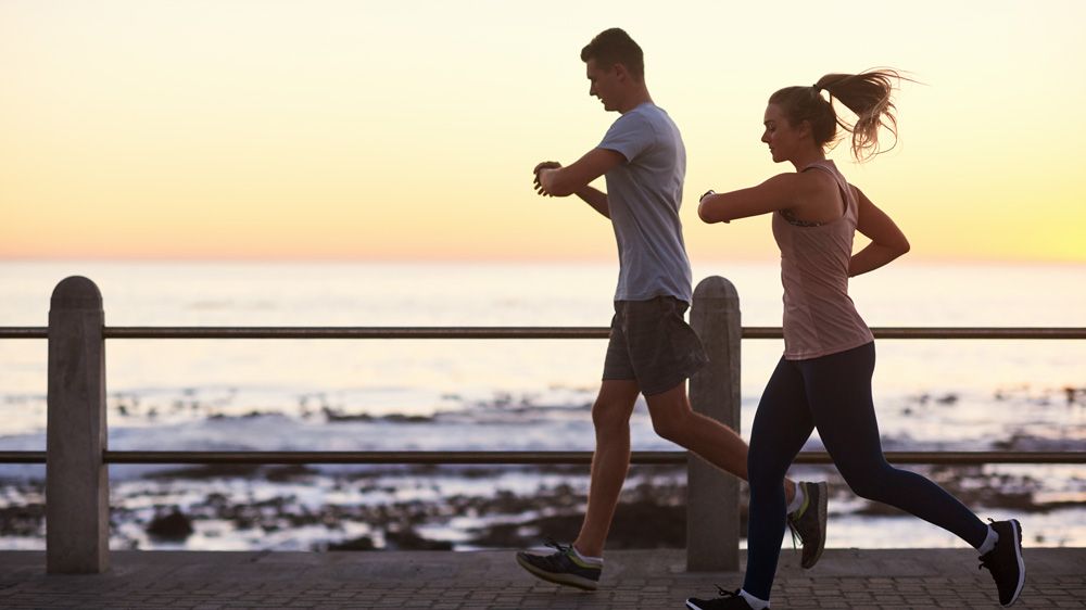 Runners looking at fitness trackers