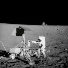 A television camera and several other pieces were taken from Surveyor 3 and brought back to Earth for scientific examination. Here, Apollo 12 moonwalker, Pete Conrad, examines the Surveyor&rsquo;s TV camera before detaching the gear.