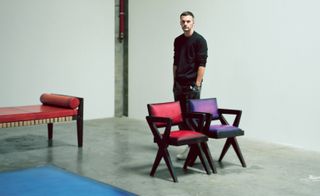 Kris van Assche stands next to Berluti furniture