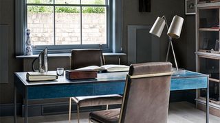 Home office with black walls and turquoise desk bold decorating choice but named key paint colors that could devalue your home