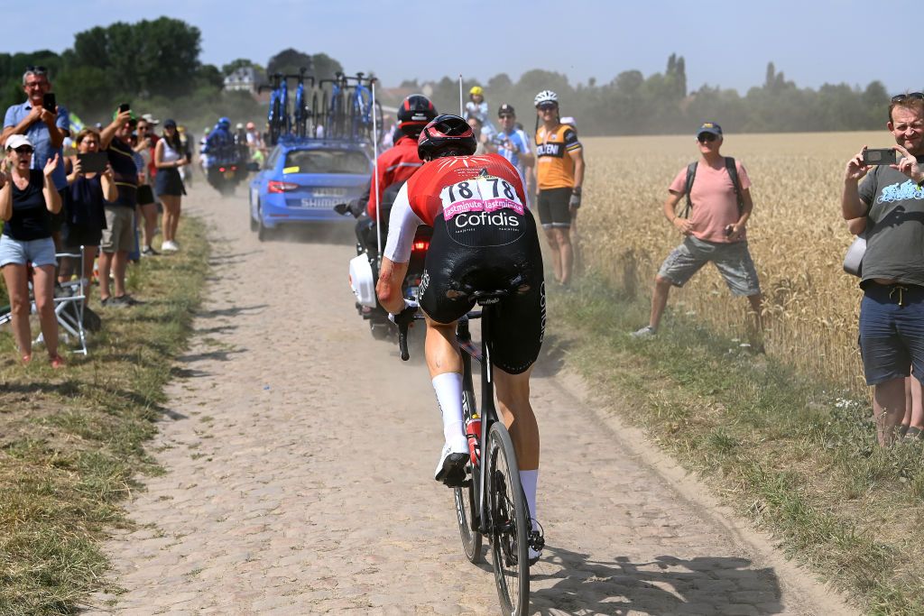 WALLERS FRANCE JULY 06 Max Walscheid of Germany and Team Cofidis competes passing through a cobblestones sector while fans cheer during to the 109th Tour de France 2022 Stage 5 a 157km stage from Lille to WallersArenberg TDF2022 WorldTour on July 06 2022 in Wallers France Photo by Tim de WaeleGetty Images