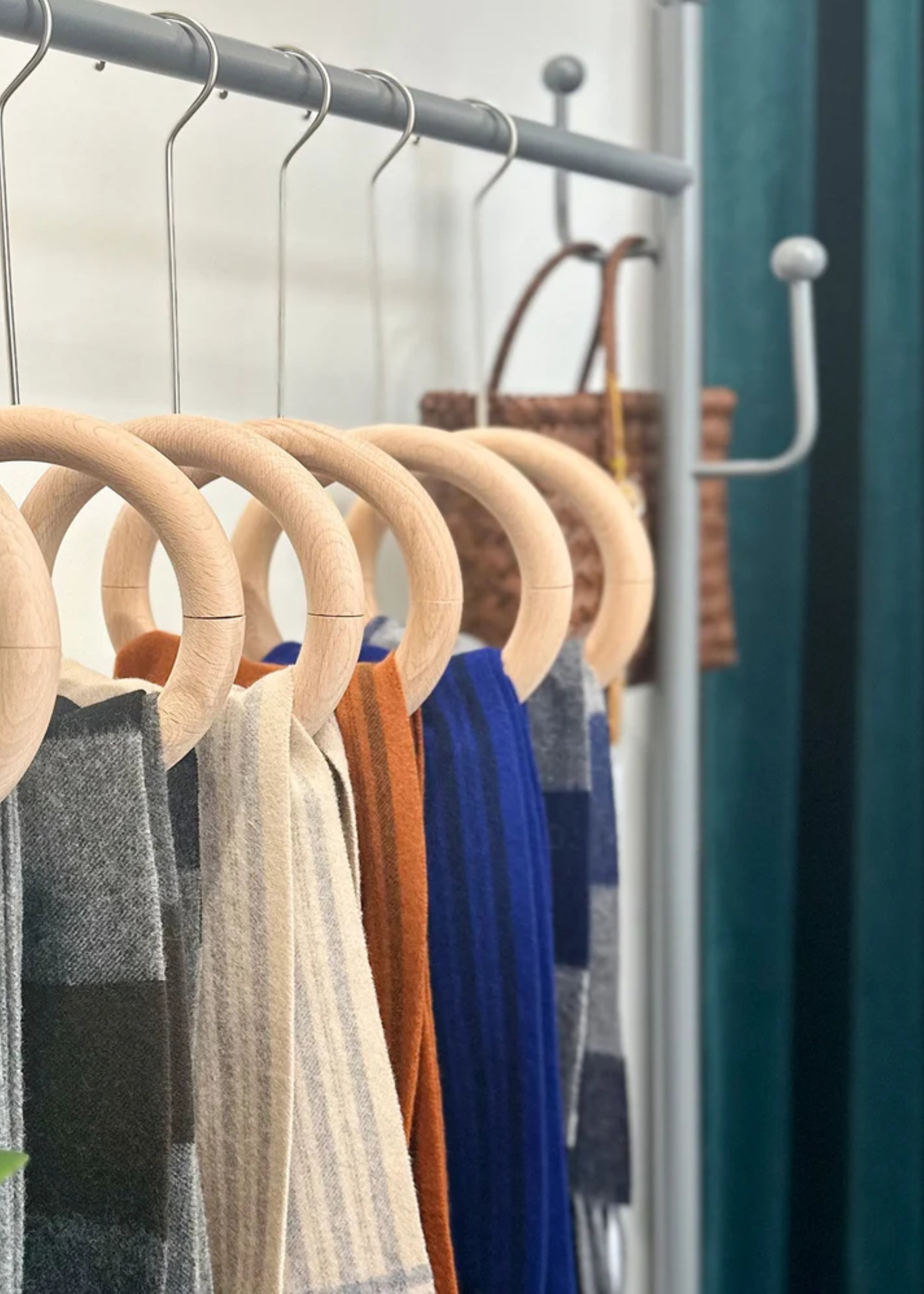 A display rack of scarves on ring hangers
