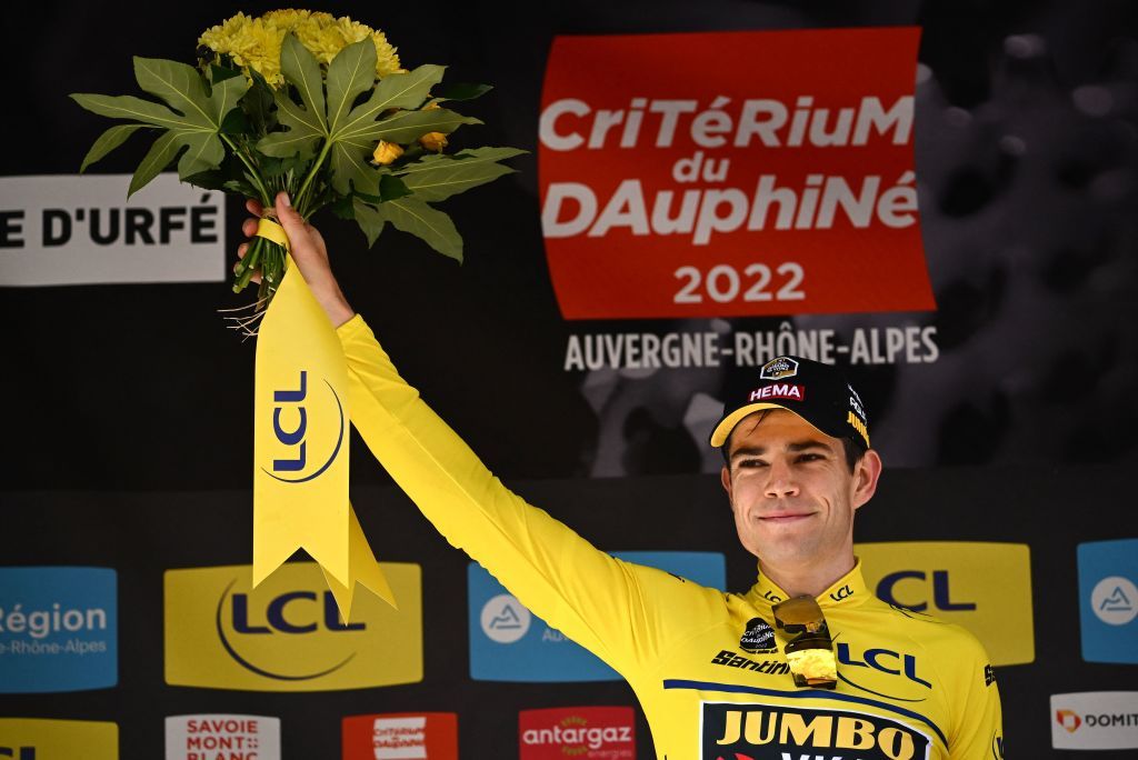 JumboVisma teams Belgian rider Wout Van Aert celebrates on the podium as he keeps the overall leaders yellow jersey after the fourth stage of the 74th edition of the Criterium du Dauphine individual time trial cycling race 319 km between Montbrison and La Batie dUrfe central eastern France on June 8 2022 Photo by Marco BERTORELLO AFP Photo by MARCO BERTORELLOAFP via Getty Images