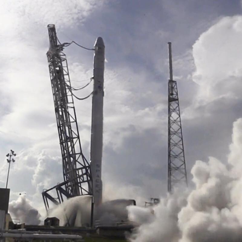 SpaceX checks its next Falcon 9 rocket to fly in a static engine test ahead of a planned April 13, 2015 launch to send an unmanned Dragon cargo ship to the International Space Station, then attempt a reusable rocket landing on an ocean platform.