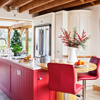 country kitchen with red units and breakfast bar