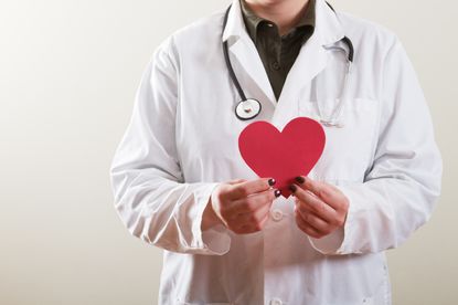 Doctor holding a paper heart