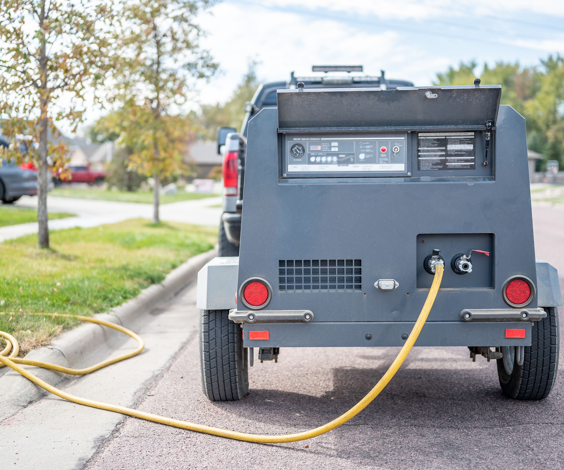 Winterizing a residential irrigation system by using a compressor and forced air to blow the lines empty