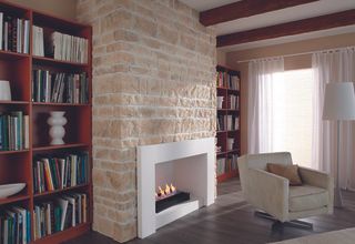 Stone fireplace with inset gas fire in cosy living room