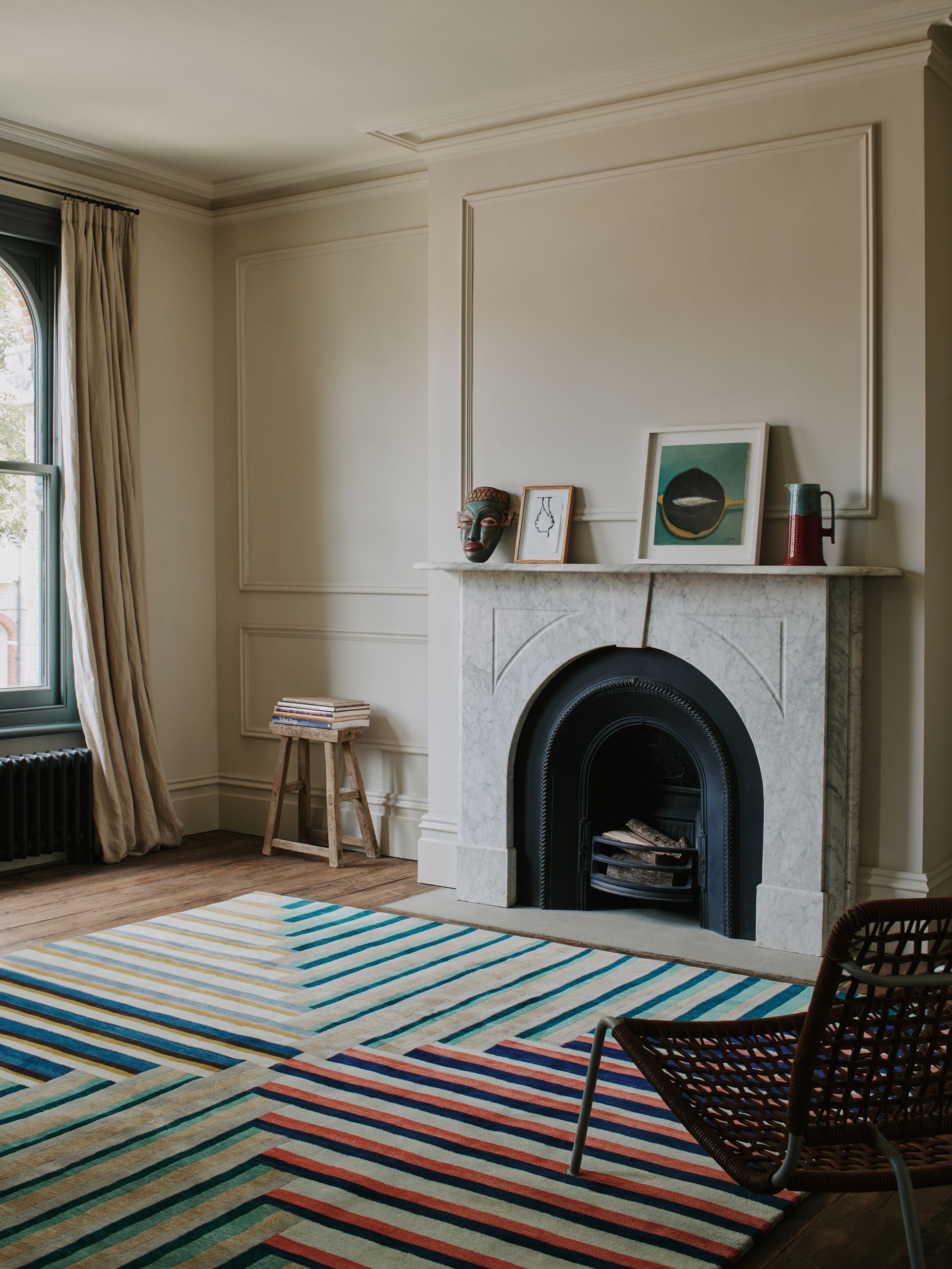 Living room with fireplace, neutral painted walls and geometric rug