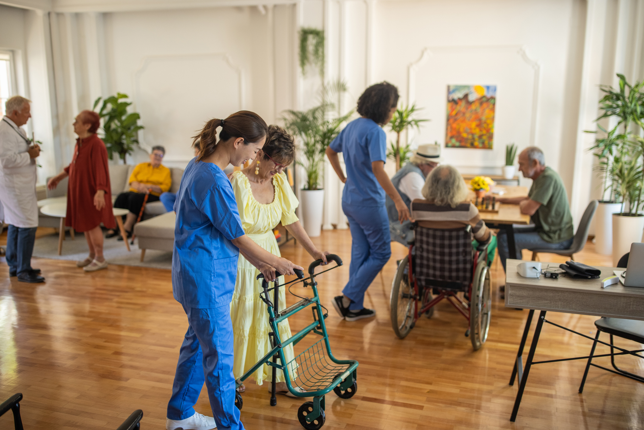 Usual day in crowded nursing home, healthcare workers working with senior people in nursing home.