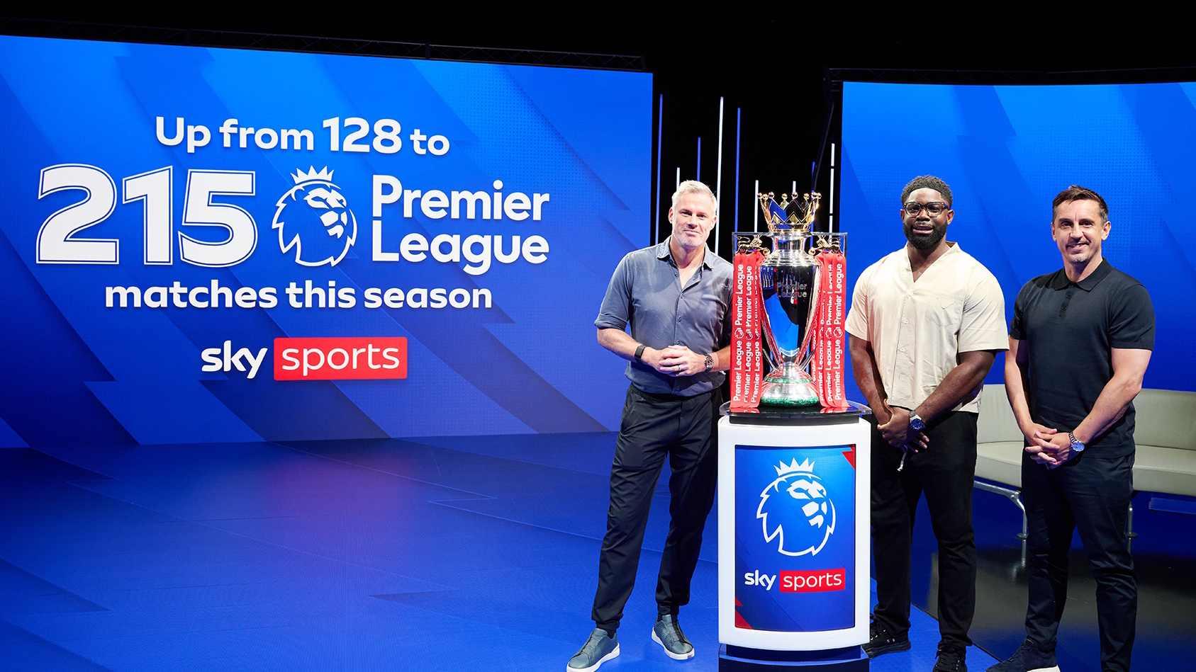 Soccer pundits Jamie Carragher, Micah Richards and Gary Neville posing with the Premier League trophy in front of a graphic advertising the amount of EPL games being shown by Sky Sports.