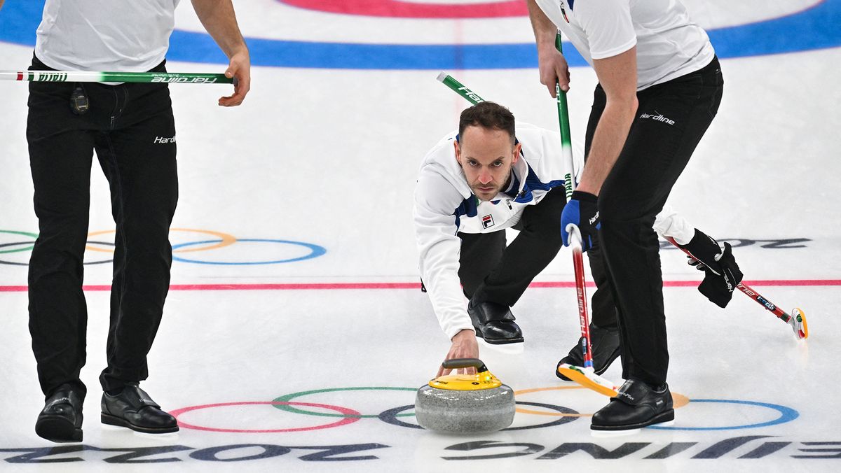 Italy&#039;s Joel Retornaz curls the stone during the men&#039;s round robin session 7 game of the Beijing 2022 Winter Olympic Games curling competition against Switzerland at the National Aquatics Centre in Beijing on February 13, 2022