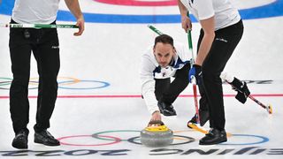 Italy's Joel Retornaz curls the stone during the men's round robin session 7 game of the Beijing 2022 Winter Olympic Games curling competition against Switzerland at the National Aquatics Centre in Beijing on February 13, 2022