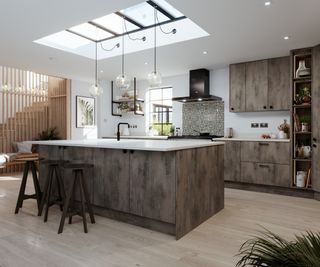 large kitchen with brown mottled effect units and large skylight above breakfast bar
