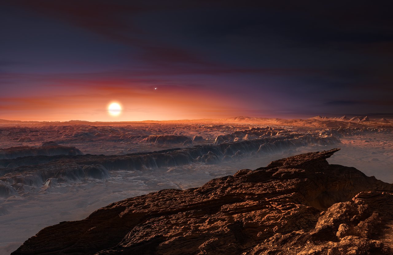 A rocky, ridgy planetary surface with large red sun in its sky