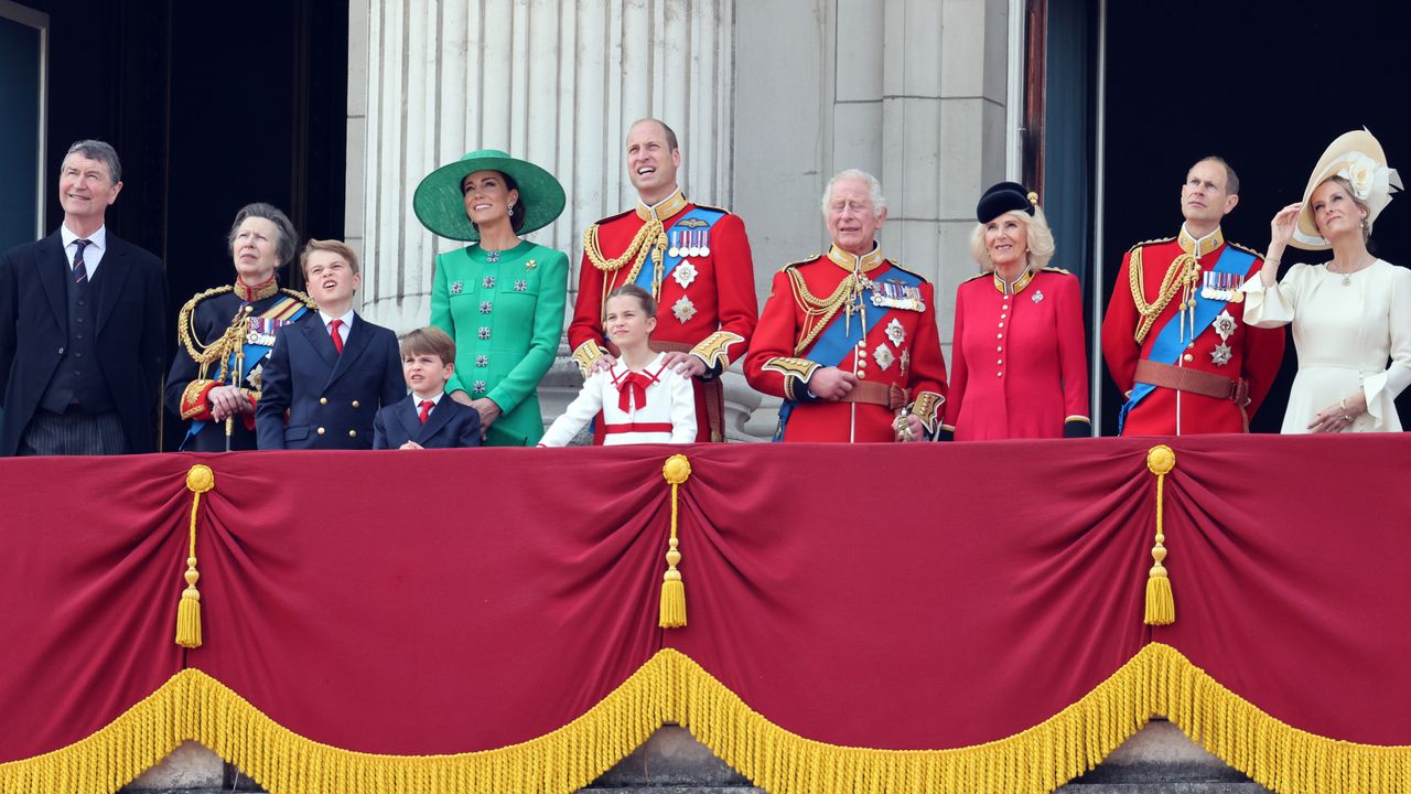 The King, Queen and other members of the royal family in dresses and military uniforms on the balcony at Buckingham Palace during Trooping the Colour 2023