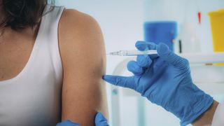 Should I exercise after my COVID vaccine? Woman being vaccinated