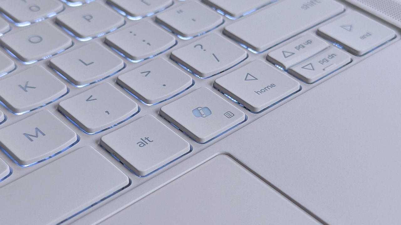 Close-up of a Lenovo Yoga Slim 7i Ultra (Gen 11) Aura Edition laptop keyboard showing keys like "alt," directional arrows, and a Windows Copilot key.