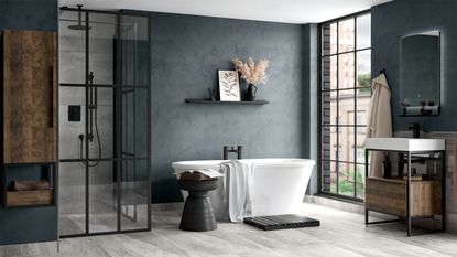 Luxe bathroom with green marble floor, wooden wall-hung vanity and modern white freestanding bath