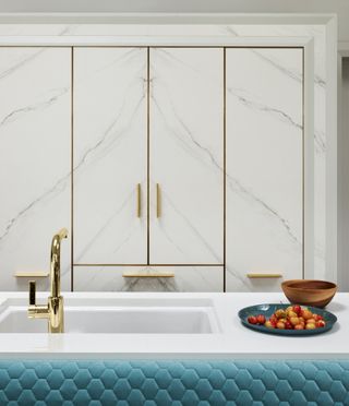 Glam marble effect kitchen cupboards with gold detailing and a gold tap