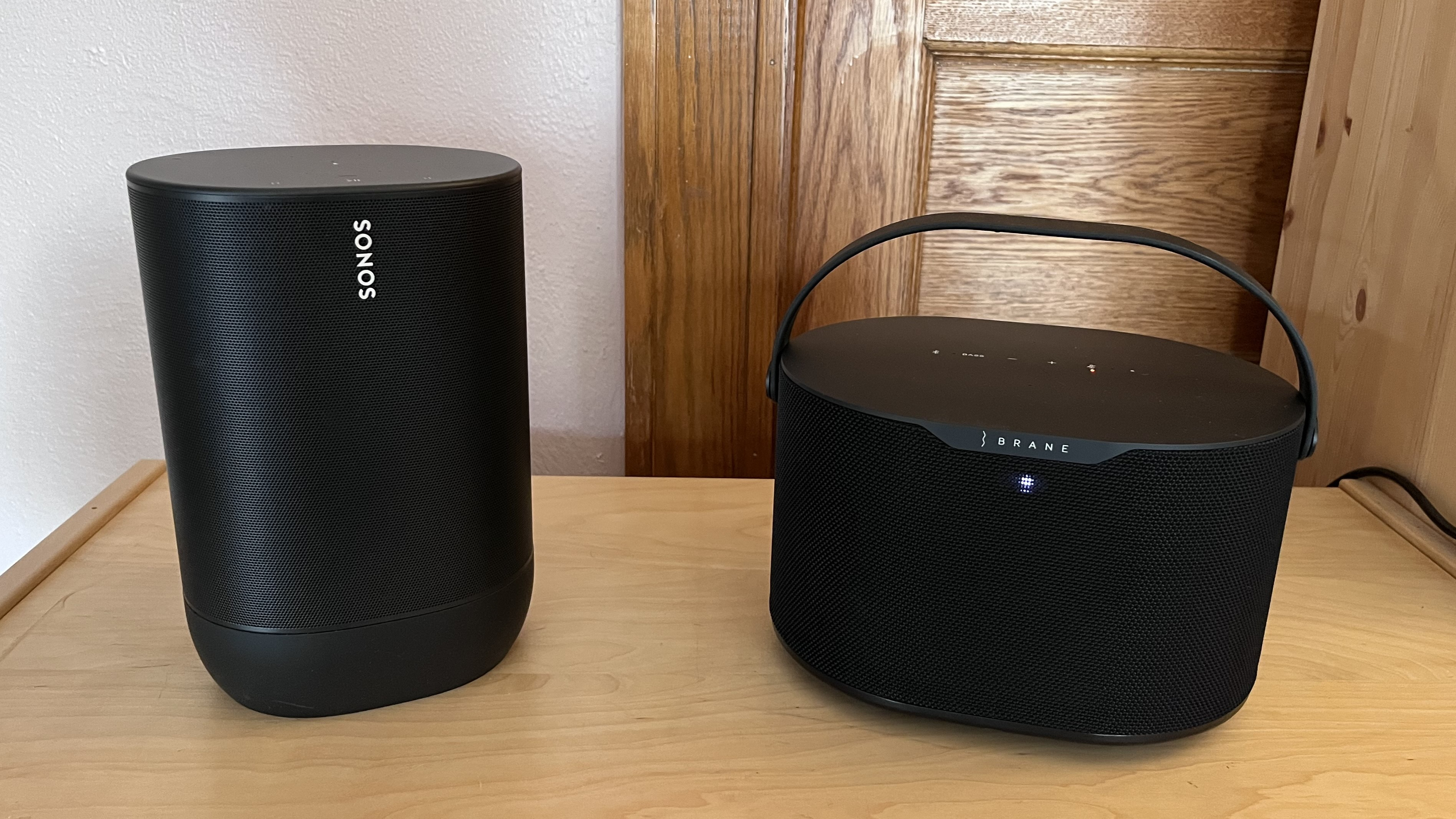 Brane X smart speaker on table next to Sonos Move