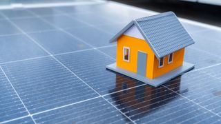 model of house on top of solar panel