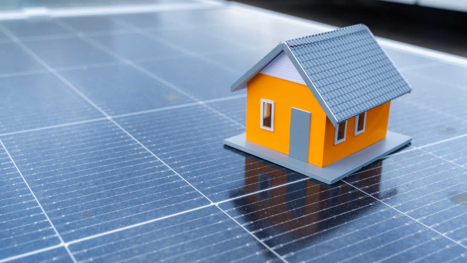 model of house on top of solar panel