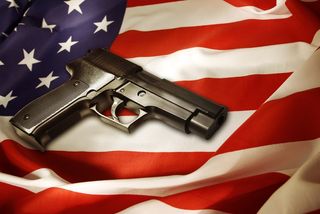 Handgun lying on American flag.