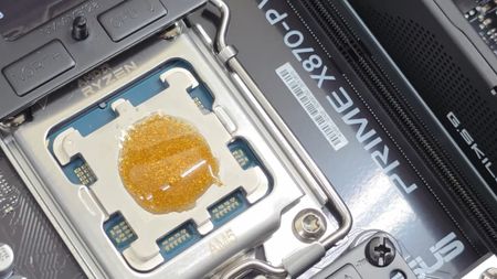 Edible thermal paste made from gold and honey atop an AMD CPU in its motherboard socket
