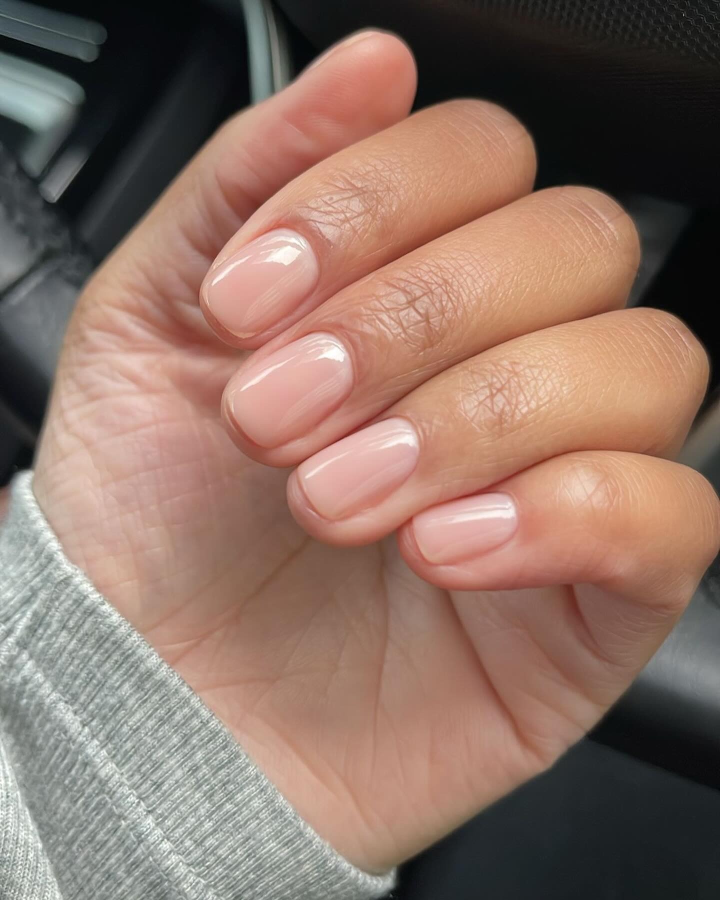 A short, slightly rounded nude manicure look