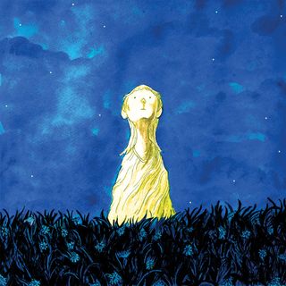 A golden dress in a field at night