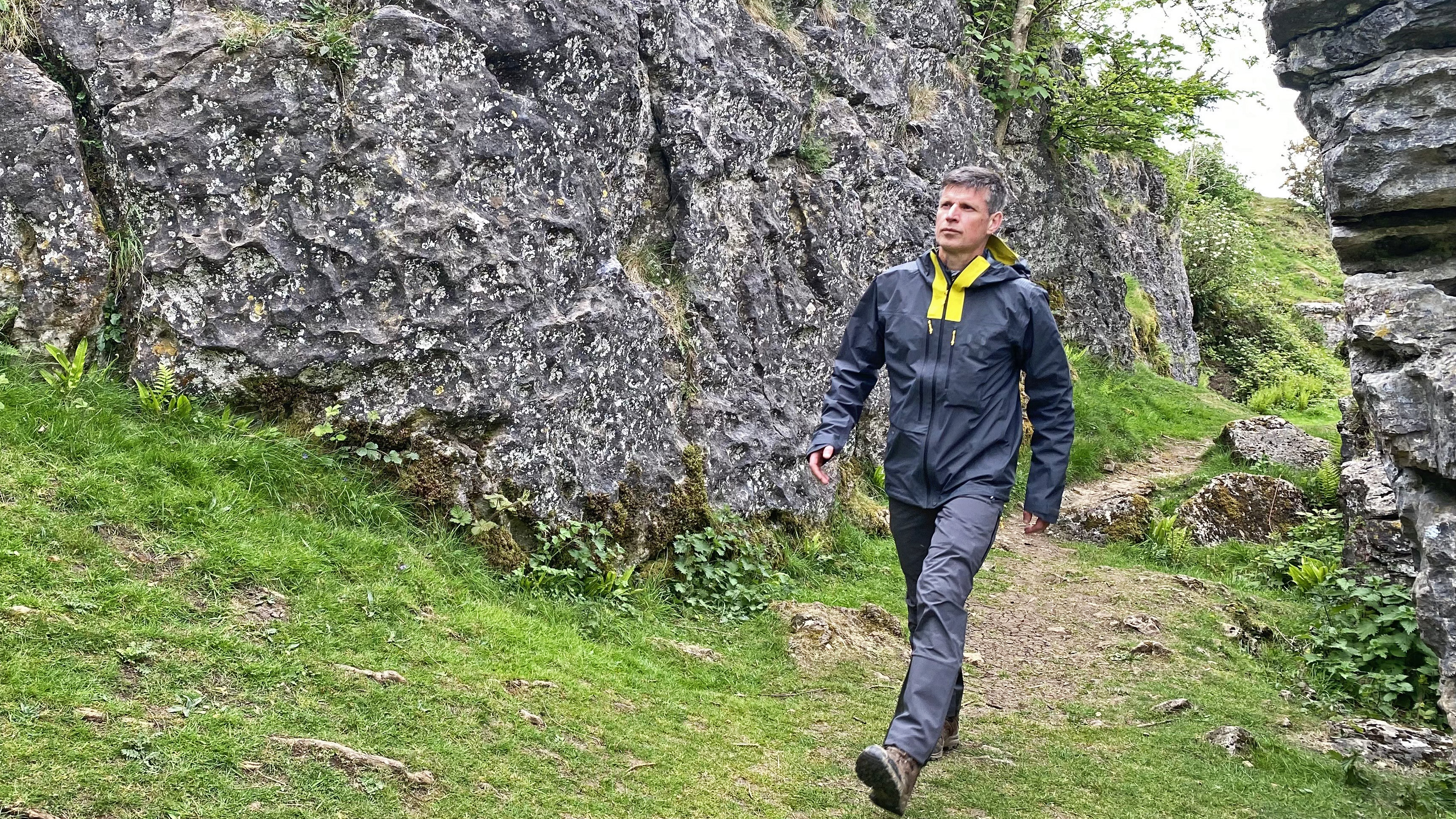 Hiking wearing the Haglöfs L.I.M ZT II GTX jacket on a craggy trail in the Mendip Hills