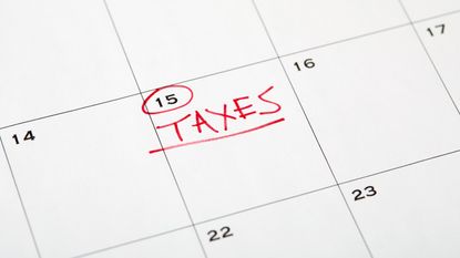 Taxes written in red and underlined on the 15th on a calendar 