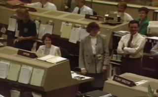 NASA officials in Mission Control laugh as a recorded wakeup call from actor Robin Williams is broadcast to the space shuttle Discovery during the STS-26 mission in 1988.