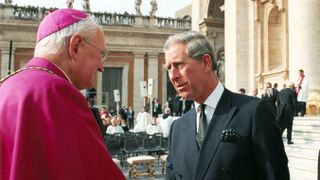 American Archbishop James Harvey, head of papal protocol, shakes hands with Prince Charles