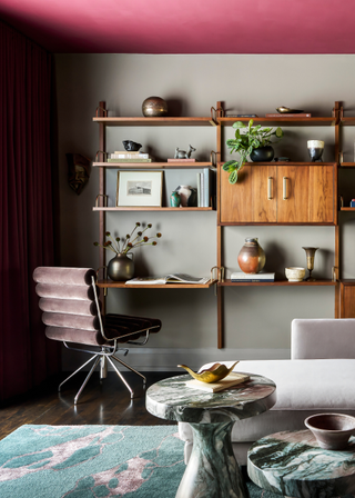 A colorful work from home space with a desk/shelf hybrid