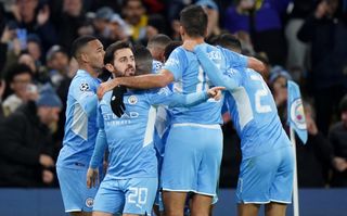 Manchester City’s Bernardo Silva (second left) and team-mates celebrate their first goal scored by Raheem Sterling (hidden) during the UEFA Champions League, Group A match at the Etihad Stadium, Manchester. Picture date: Wednesday November 24, 2021