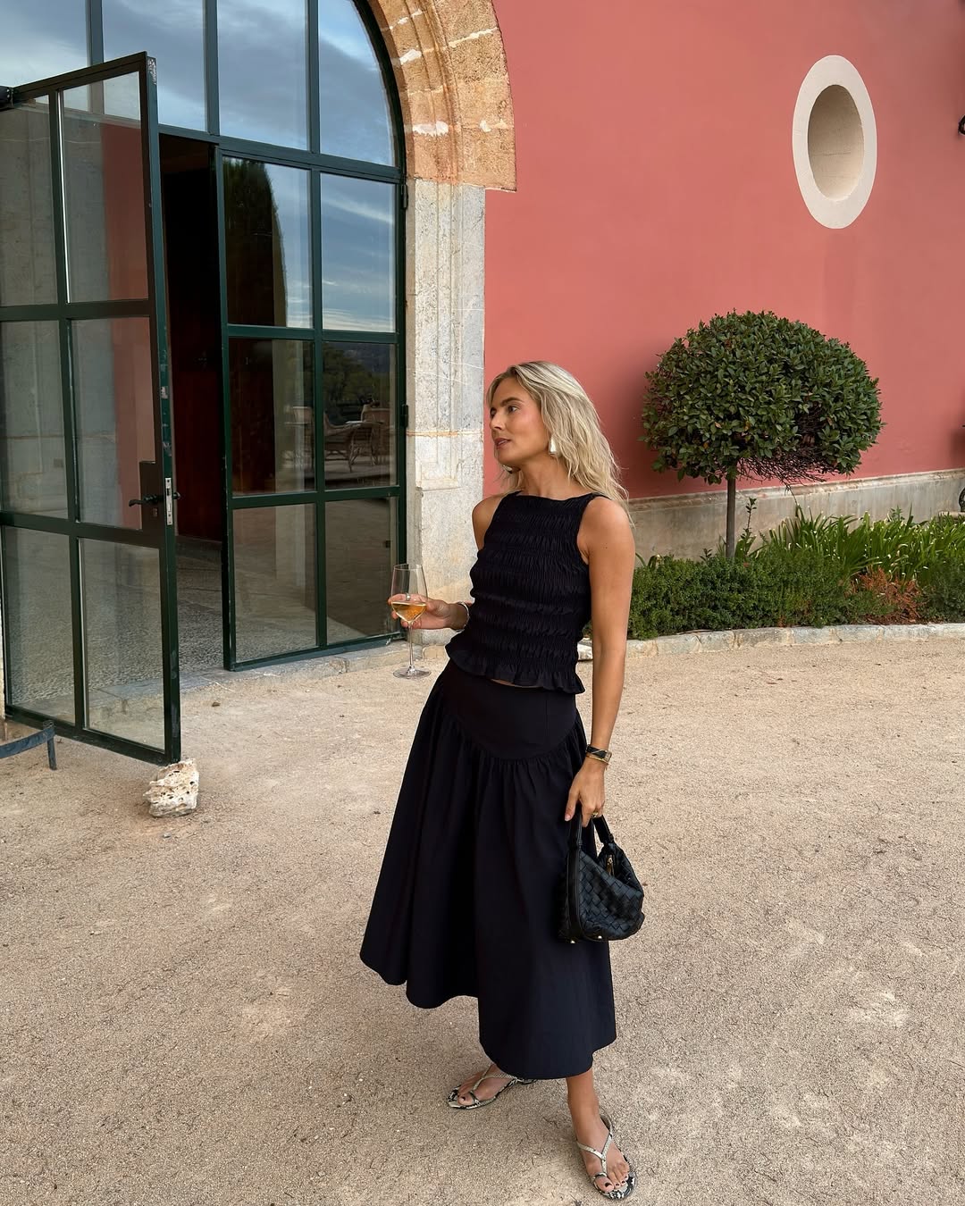 @lucywilliams02 wearing black top and skirt and snakeprint sandals