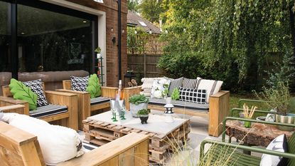 garden patio with pallet table and wood furniture