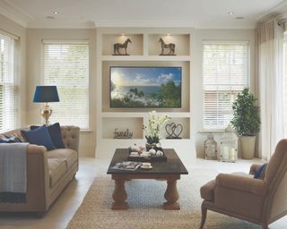 A traditional living room with a media room featuring recessed shelving