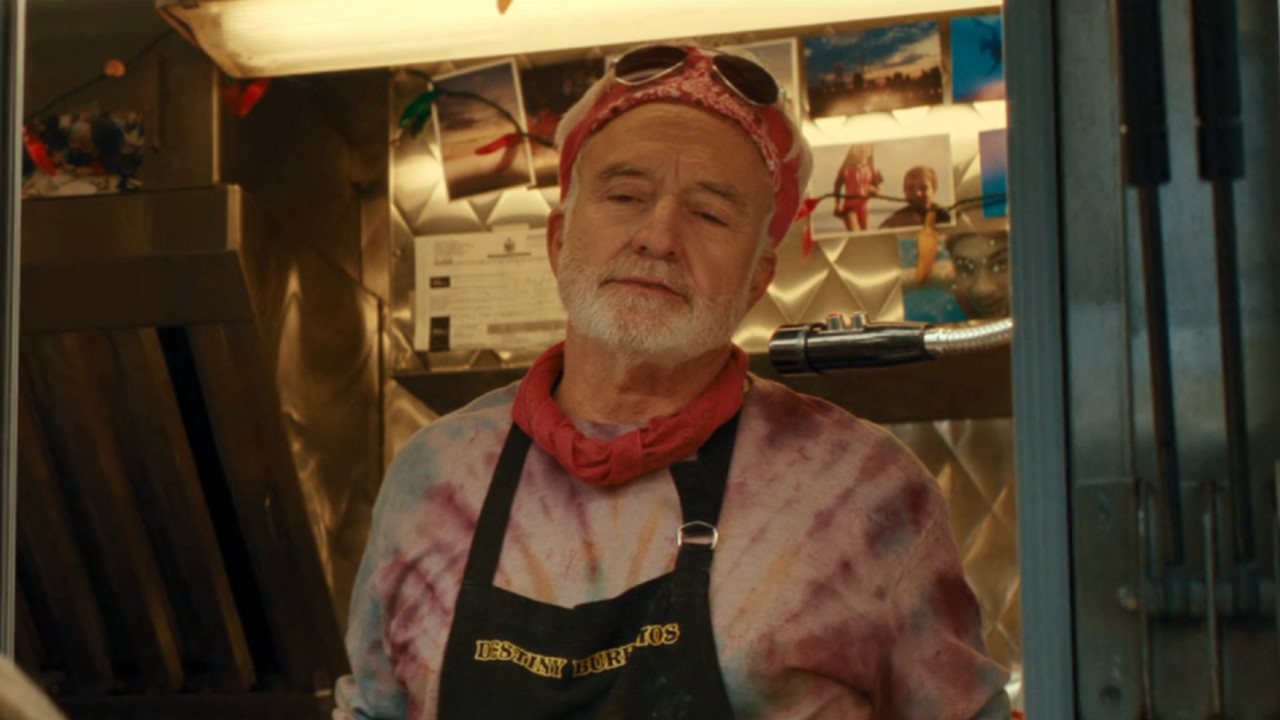 Bradley Whitford as Peter Vance wearing a tie-die shirt, two red bandanas and sunglasses while standing in a food truck.