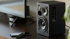 Black matted Bluetooth speakers on a desk