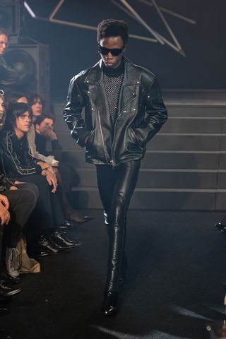Man on Celine runway in black leather jacket and leather trousers